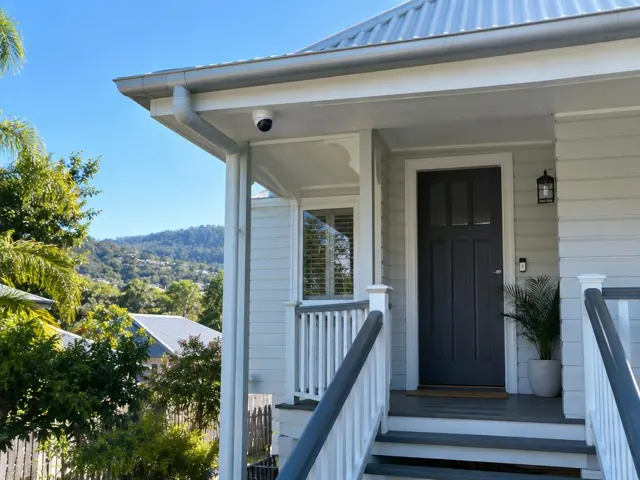 Front porch with a security camera under the eave on a weatherboard house in Mudgeeraba